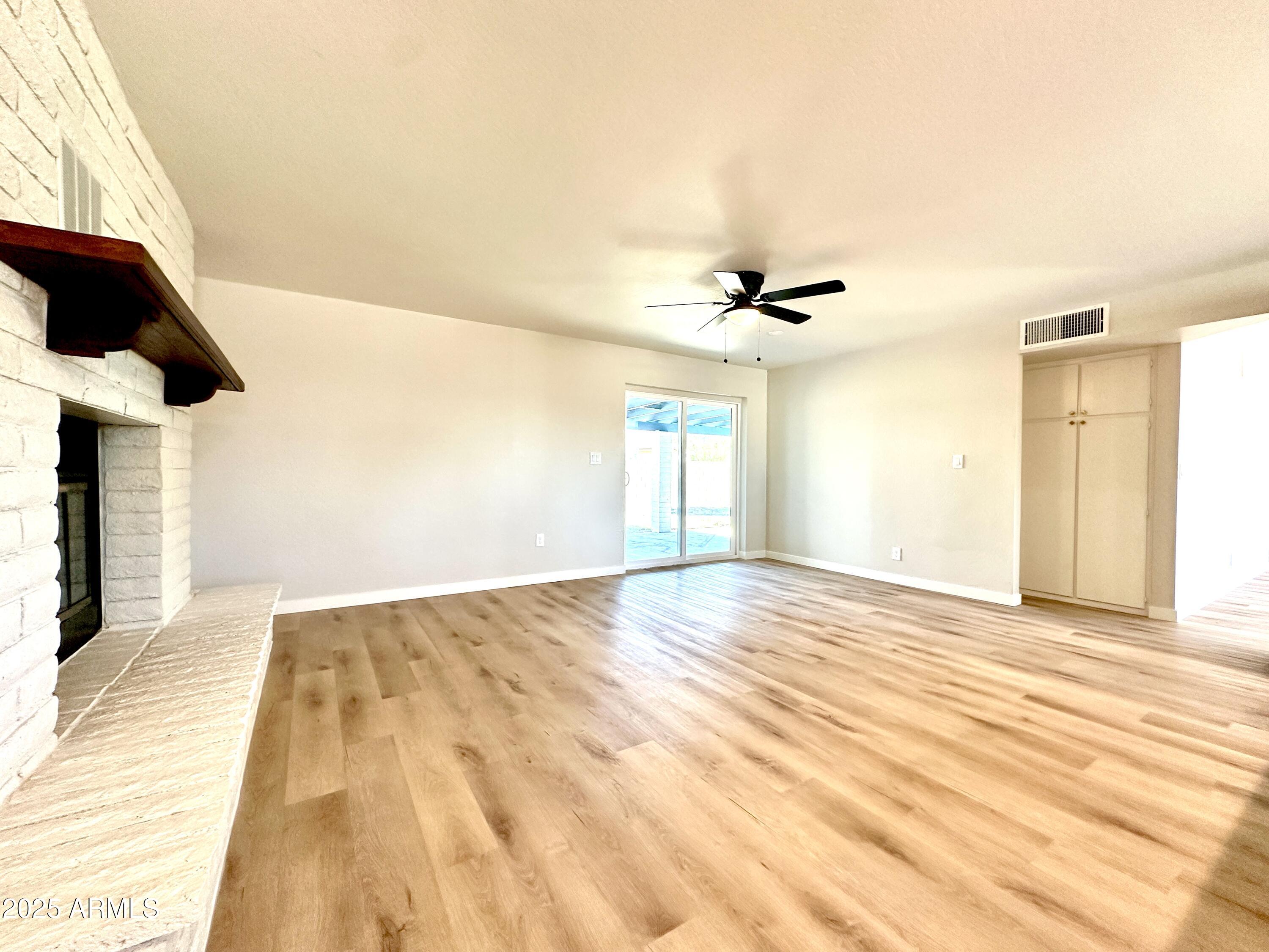 1188 North 4th Street Coolidge, AZ 85128 - Photo 8 of 26 a view of empty room with wooden floor and fan
