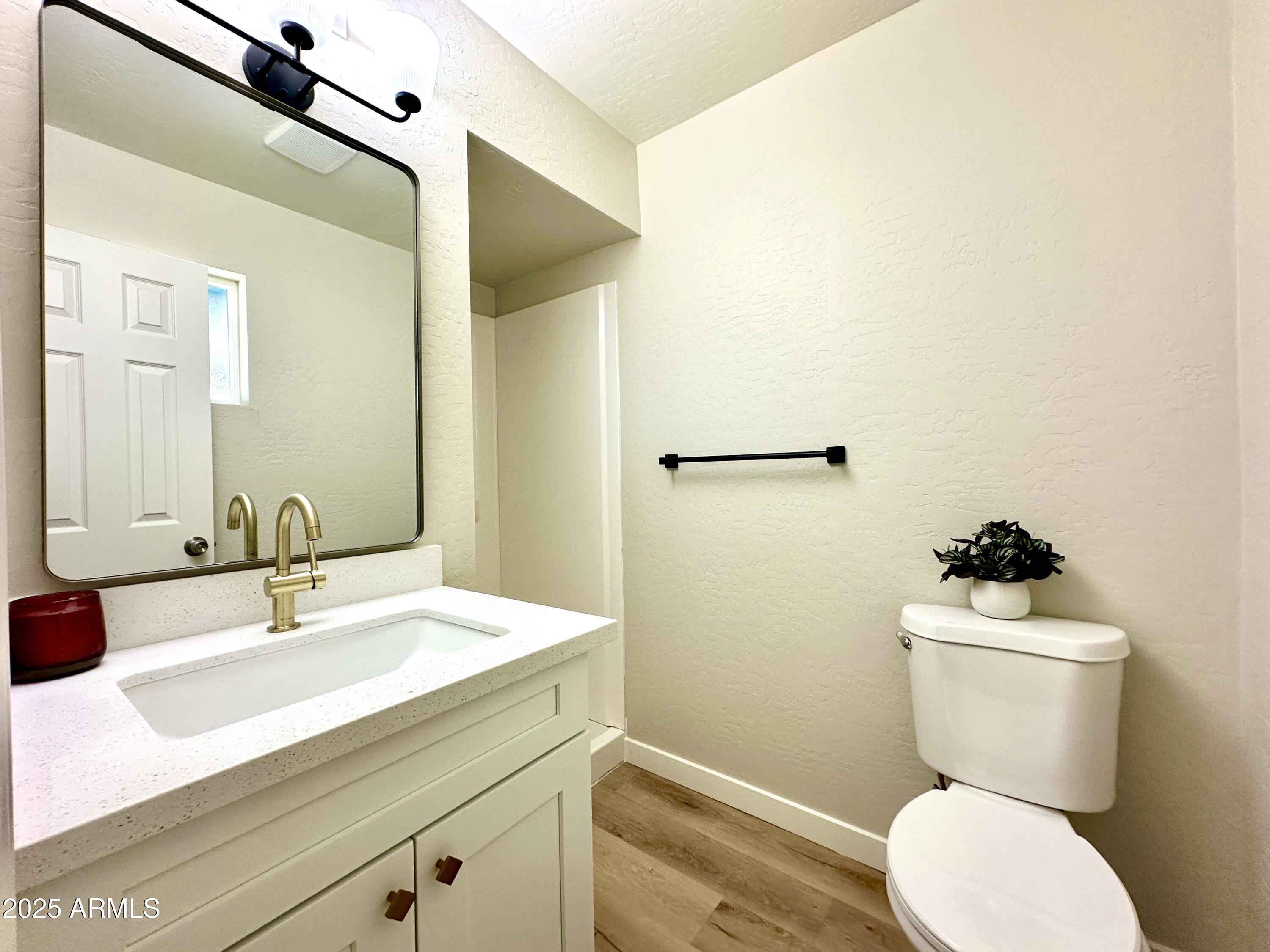 1188 North 4th Street Coolidge, AZ 85128 - Photo 10 of 26 a bathroom with a sink mirror vanity and toilet