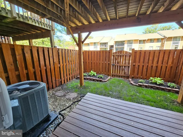 a view of a backyard with wooden fence