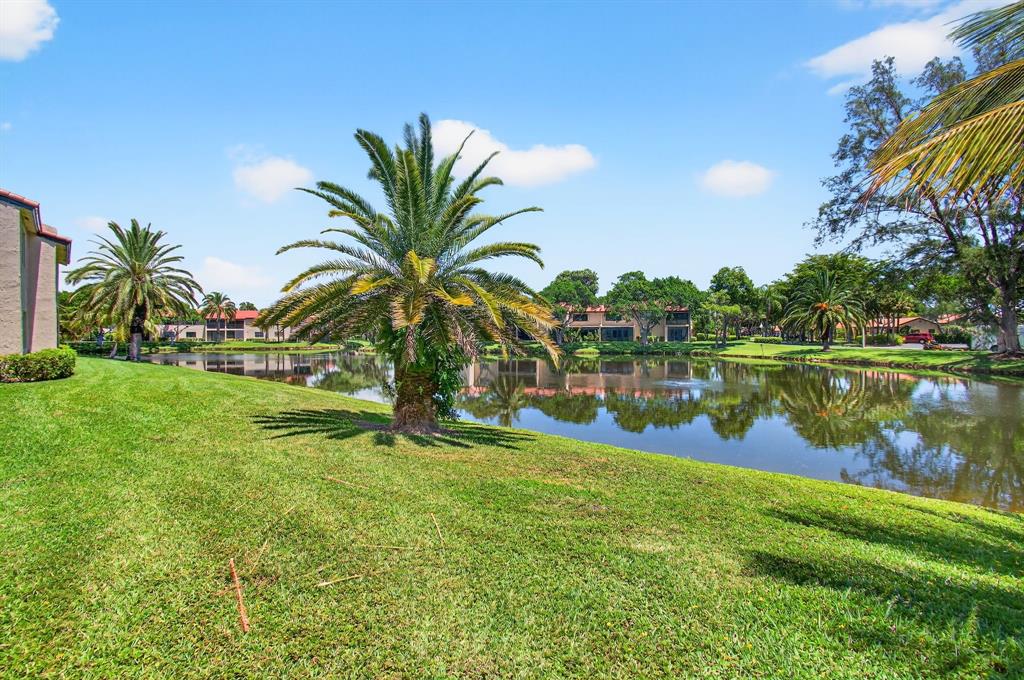 9283 Vista Del Lago, Unit 37J Boca Raton, FL 33428 - Photo 13 of 19 a view of a lake with a building in the background