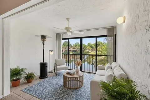 a living room with furniture and a floor to ceiling window