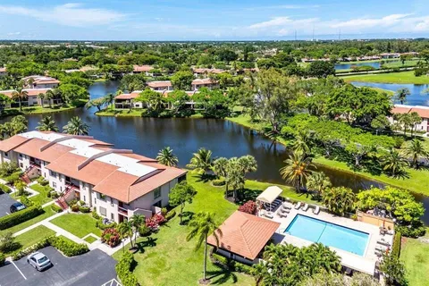 an aerial view of residential houses with outdoor space and river view