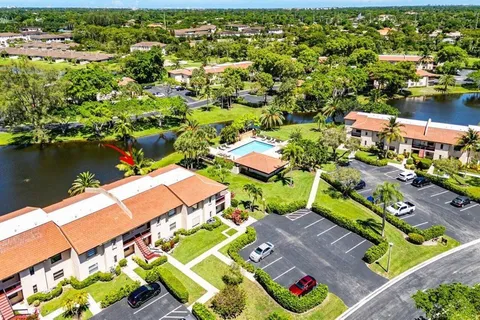a view of a balcony with chairs and a potted plant