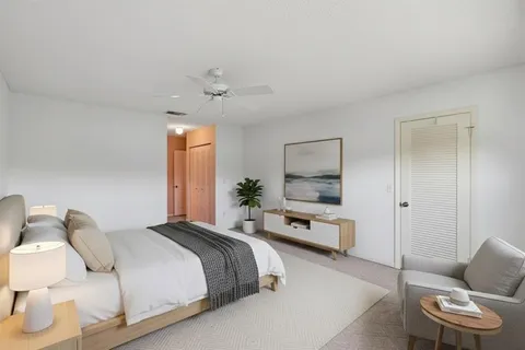 a bedroom with a bed and a chair