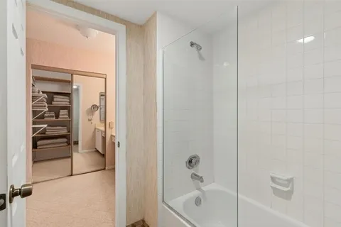 a bathroom with a bathtub and a shower