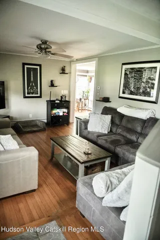 a living room with furniture and a wooden floor