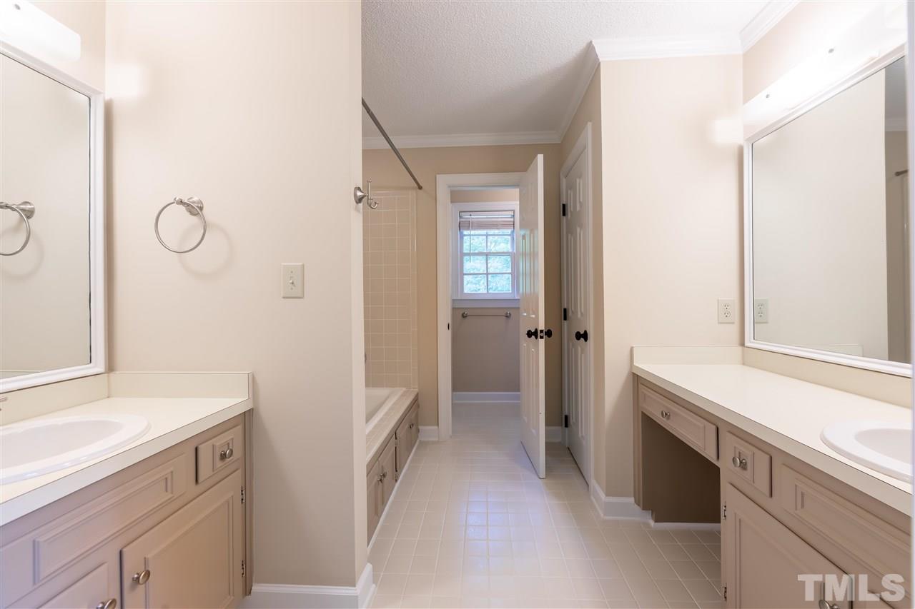 2408 Heartley Drive Raleigh, NC 27615 - Photo 15 of 26 a bathroom with a sink and a mirror