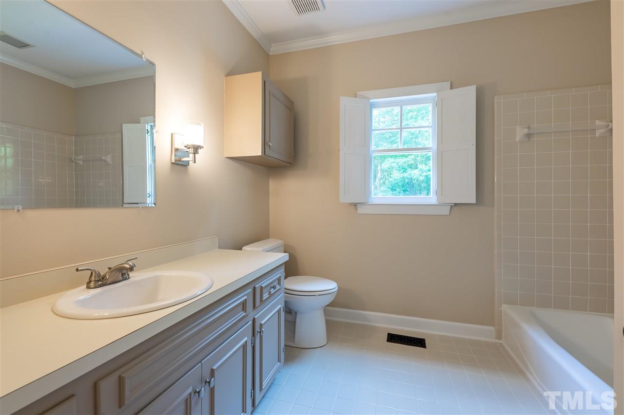 2408 Heartley Drive Raleigh, NC 27615 - Photo 19 of 26 a bathroom with a sink toilet and tub