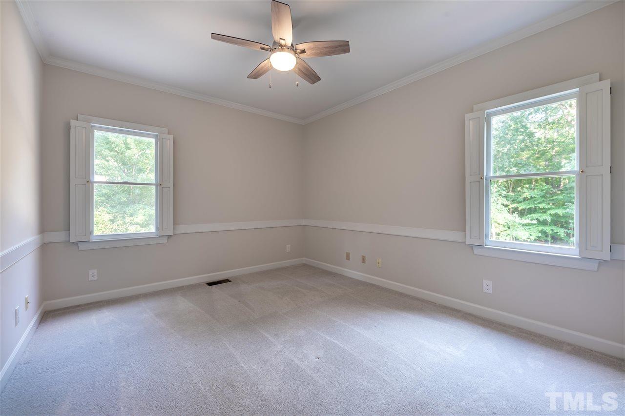 2408 Heartley Drive Raleigh, NC 27615 - Photo 20 of 26 an empty room with a window and a fan