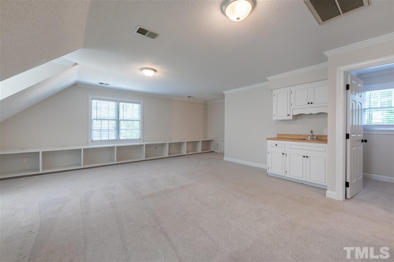 2408 Heartley Drive Raleigh, NC 27615 - Photo 22 of 26 wooden floor in an empty room with a kitchen