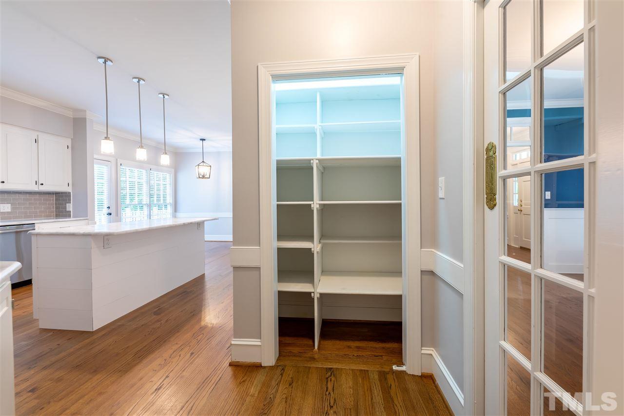 2408 Heartley Drive Raleigh, NC 27615 - Photo 5 of 26 a view of a kitchen with wooden floor and cabinets