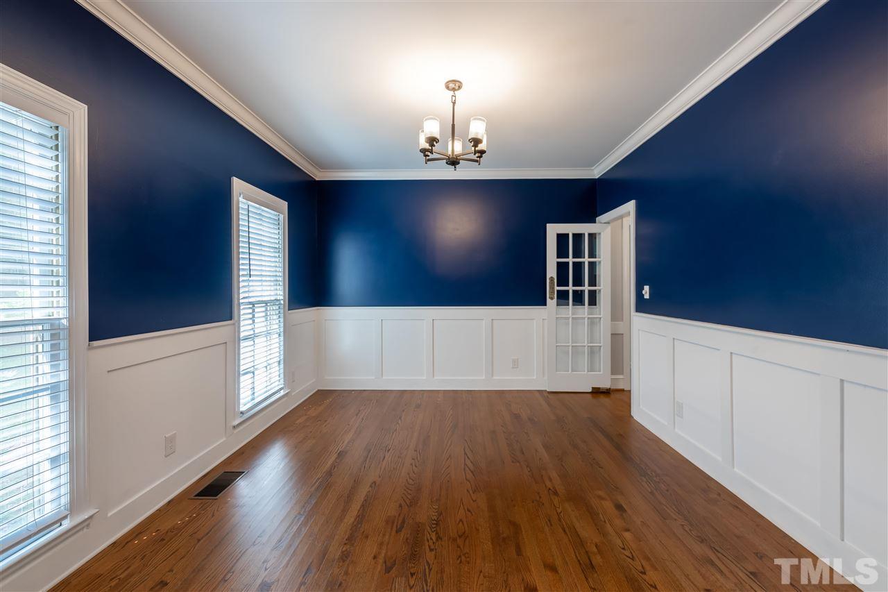 2408 Heartley Drive Raleigh, NC 27615 - Photo 7 of 26 a view of an empty room with window and wooden floor