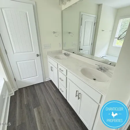 a spacious bathroom with a sink a mirror and a shower