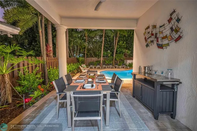 a dining room with furniture and garden view