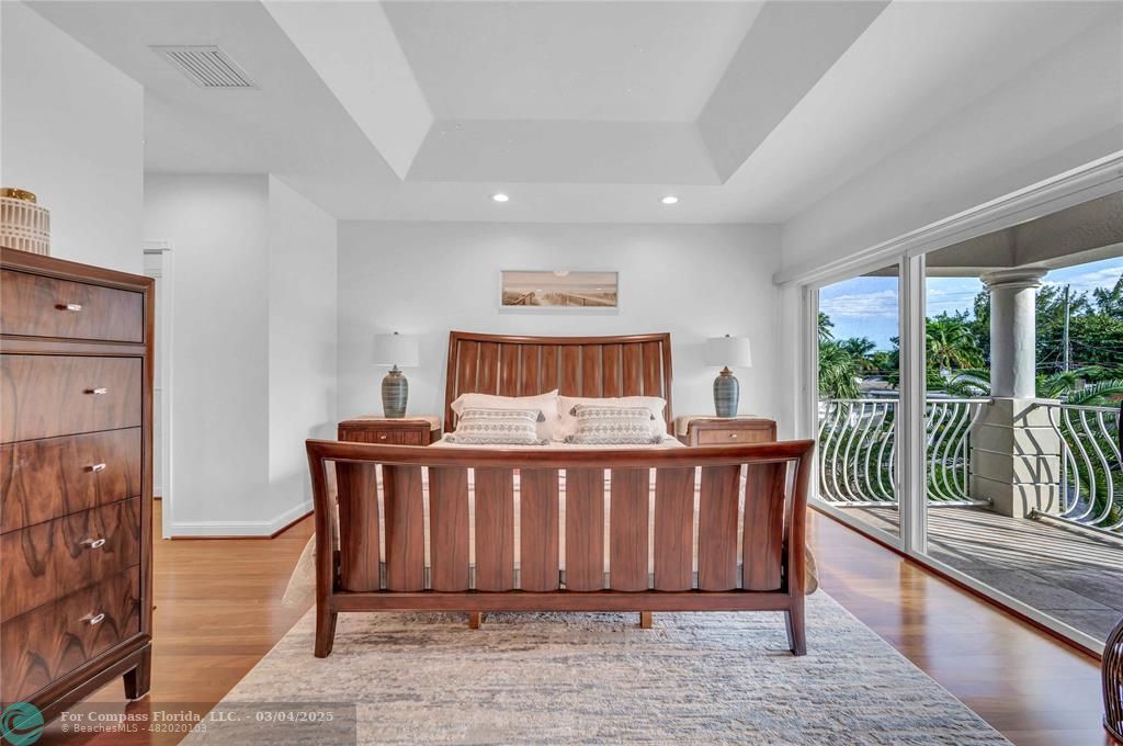 3315 Northeast 17th Street Fort Lauderdale, FL 33305 - Photo 19 of 41 a spacious bedroom with a bed and a table
