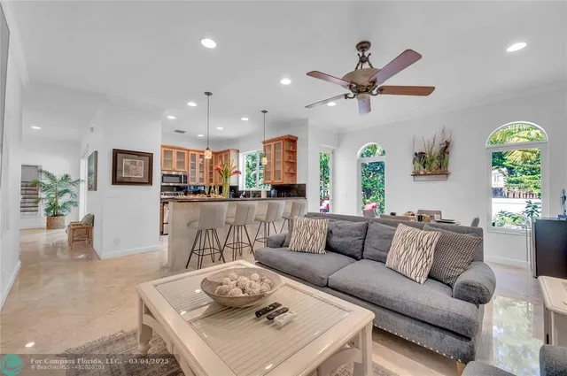 a living room with furniture kitchen and a table