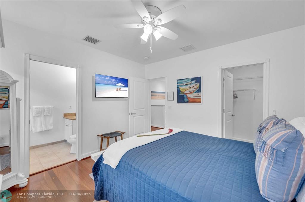 3315 Northeast 17th Street Fort Lauderdale, FL 33305 - Photo 25 of 41 a bedroom with a bed and a chandelier