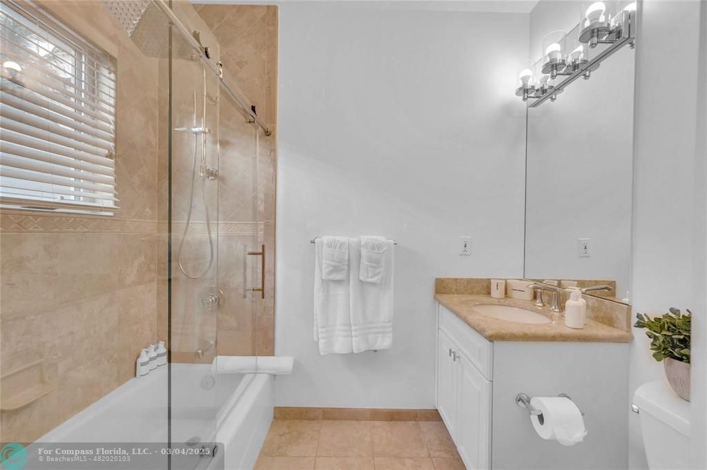 3315 Northeast 17th Street Fort Lauderdale, FL 33305 - Photo 26 of 41 a bathroom with a sink and a mirror