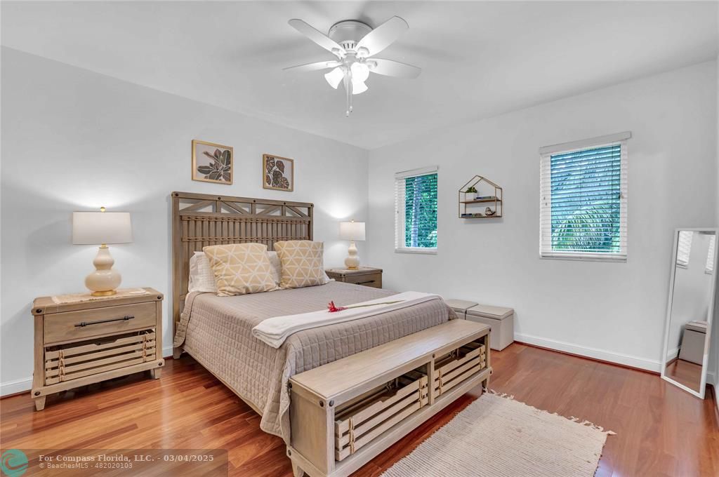 3315 Northeast 17th Street Fort Lauderdale, FL 33305 - Photo 29 of 41 a bedroom with a bed and a chandelier