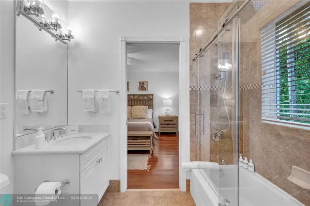 a spacious bathroom with a double vanity sink a mirror and a shower