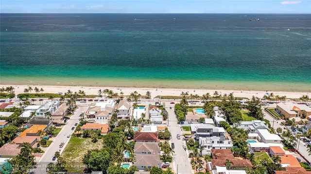 a green field with lots of trees in front of it