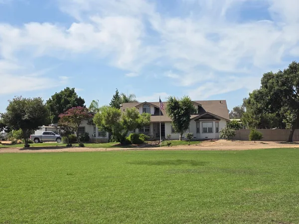 a front view of building with yard and green space