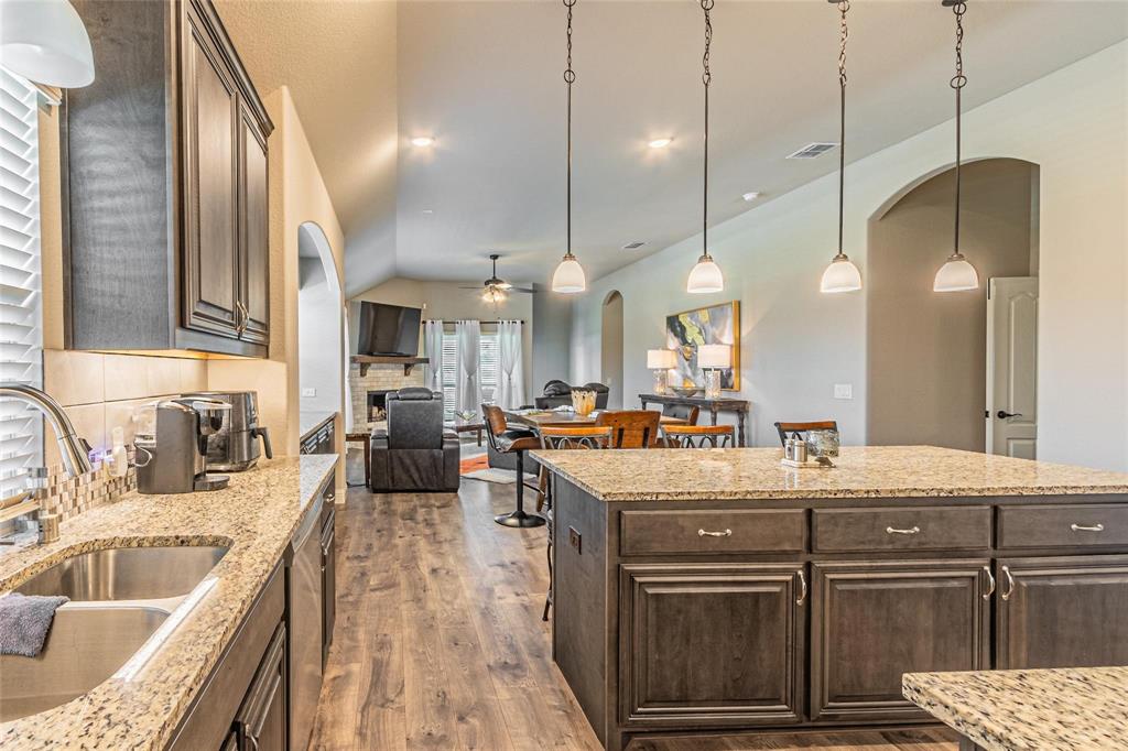 4201 Misty Ridge Street Mesquite, TX 75181 - Photo 14 of 39 Kitchen featuring decorative backsplash, pendant lighting, dark brown cabinetry, and ceiling fan