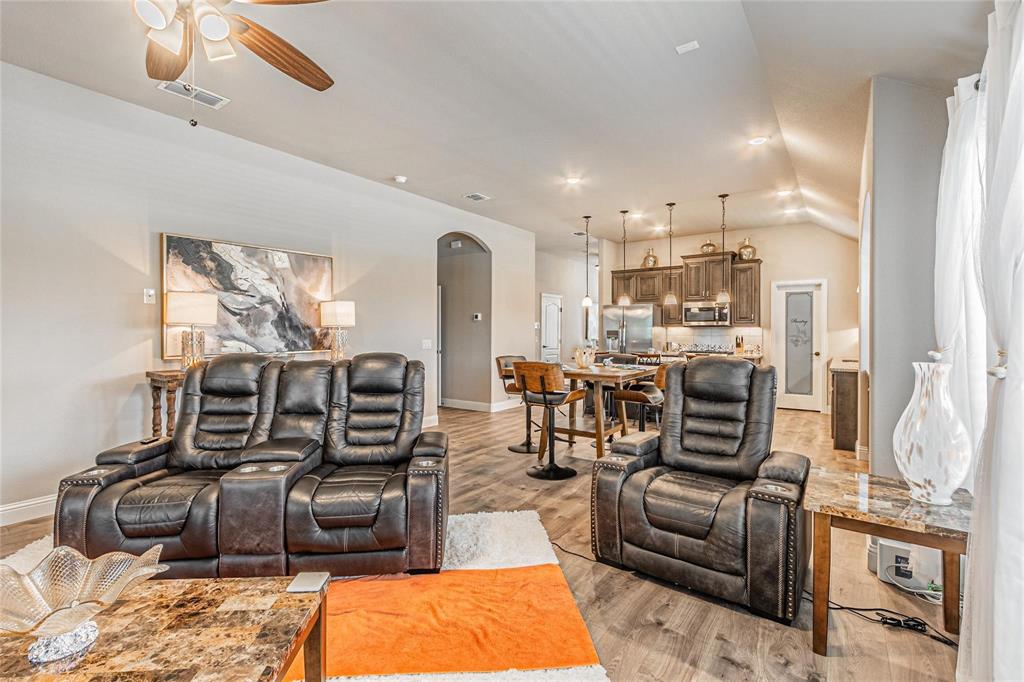 4201 Misty Ridge Street Mesquite, TX 75181 - Photo 19 of 39 Living room featuring light hardwood / wood-style flooring, ceiling fan, and lofted ceiling