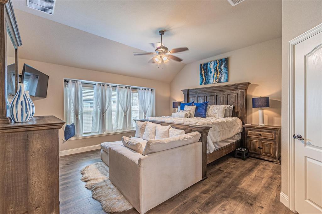 4201 Misty Ridge Street Mesquite, TX 75181 - Photo 22 of 39 Bedroom featuring ceiling fan, dark hardwood / wood-style flooring, and vaulted ceiling