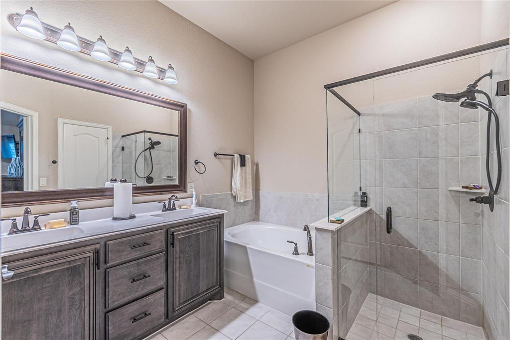 4201 Misty Ridge Street Mesquite, TX 75181 - Photo 24 of 39 Bathroom with separate shower and tub, tile patterned flooring, and vanity