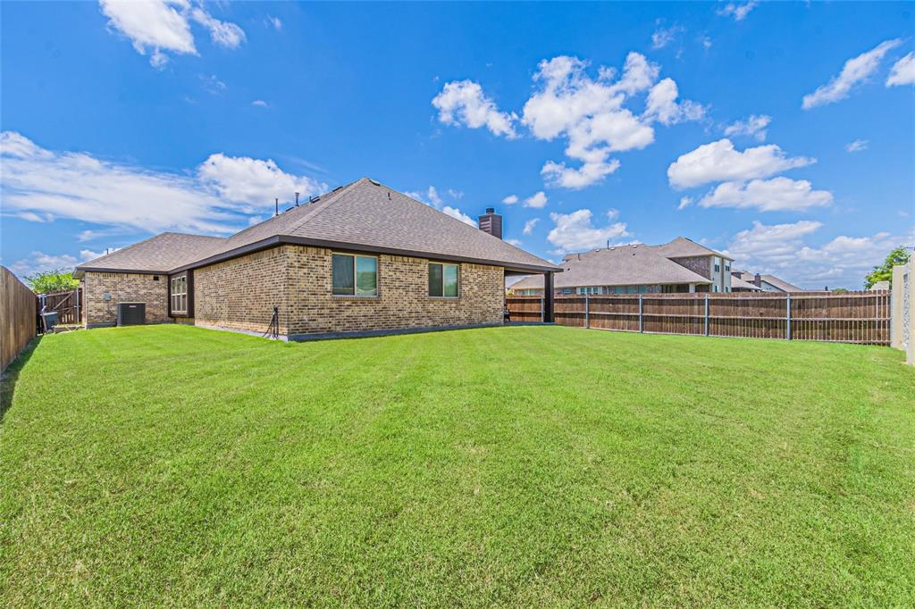 4201 Misty Ridge Street Mesquite, TX 75181 - Photo 37 of 39 Rear view of house with a yard and central AC