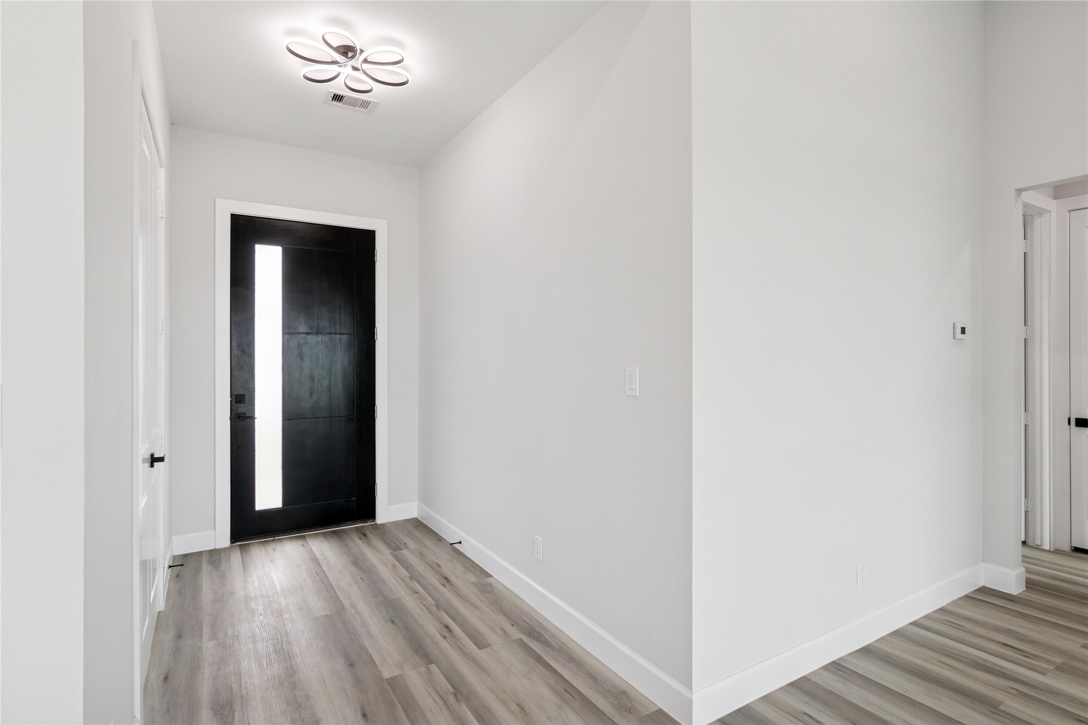 5766 Ward Bend Road Sealy, TX 77474 - Photo 6 of 45 a view of an empty room with wooden floor