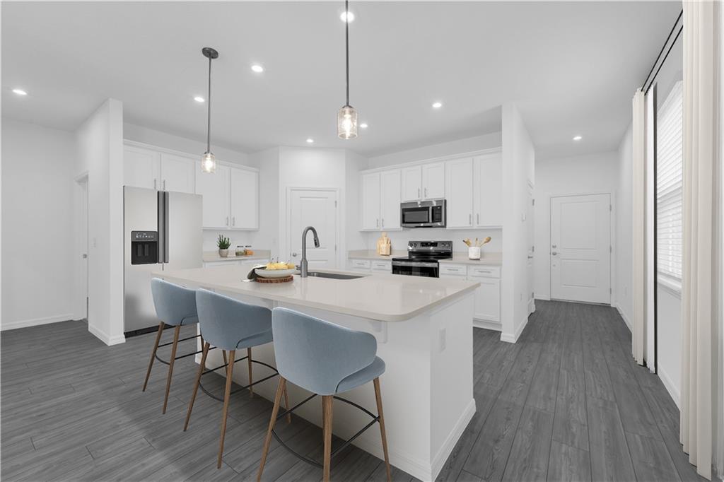 328 Cavalier Lane Acworth, GA 30102 - Photo 3 of 42 a kitchen with kitchen island appliances and wooden floor
