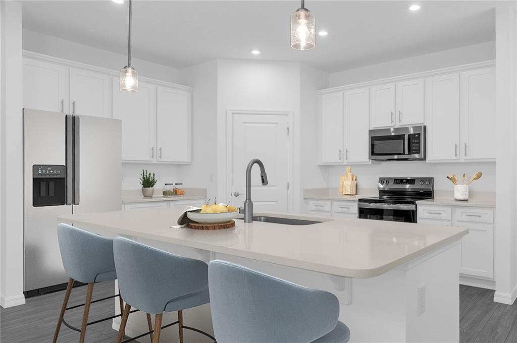 328 Cavalier Lane Acworth, GA 30102 - Photo 4 of 42 a kitchen with stainless steel appliances a stove a sink a microwave and wooden cabinets