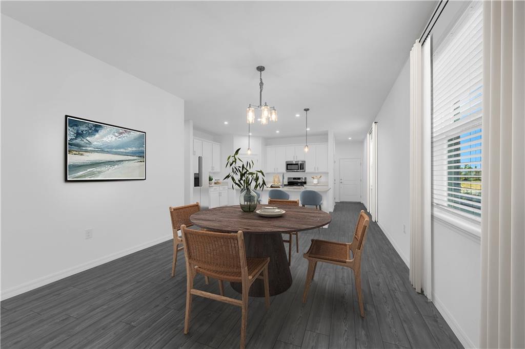 328 Cavalier Lane Acworth, GA 30102 - Photo 9 of 42 a view of a dining room with furniture wooden floor and a chandelier
