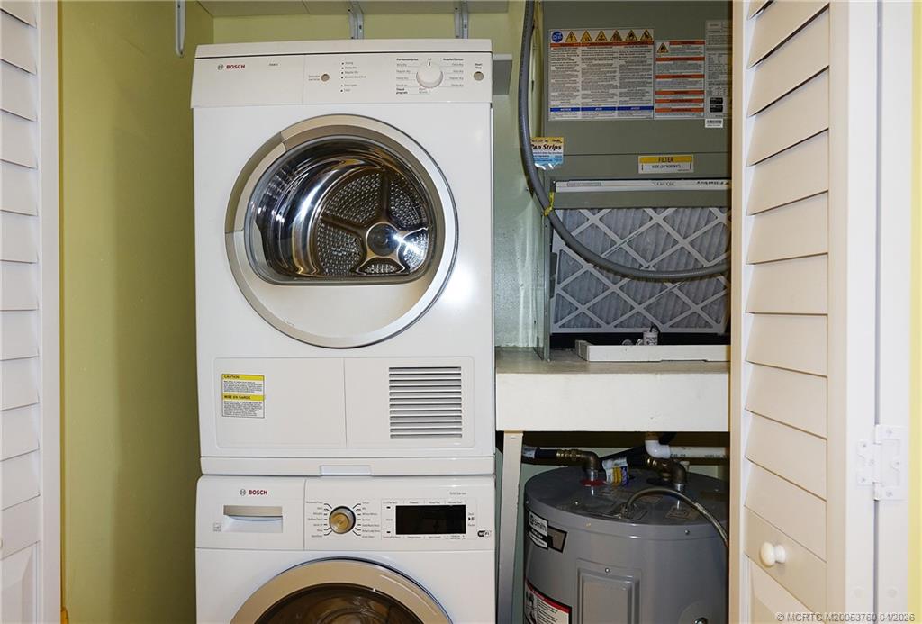 5290 Southeast Seascape Way, Unit 201 Stuart, FL 34997 - Photo 15 of 30 a utility room with dryer and washer
