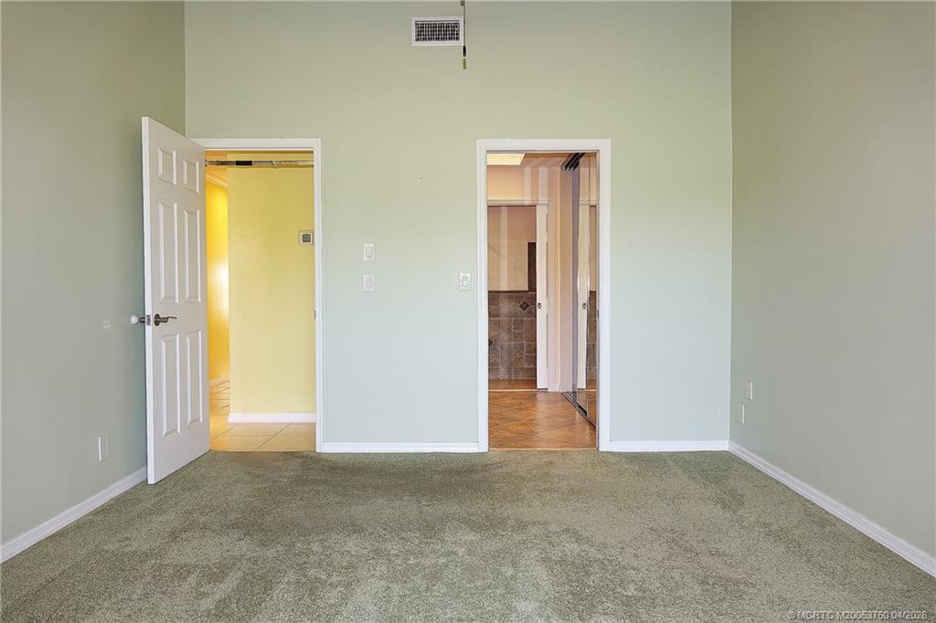 5290 Southeast Seascape Way, Unit 201 Stuart, FL 34997 - Photo 18 of 30 a view of a hallway with closet and wooden floor
