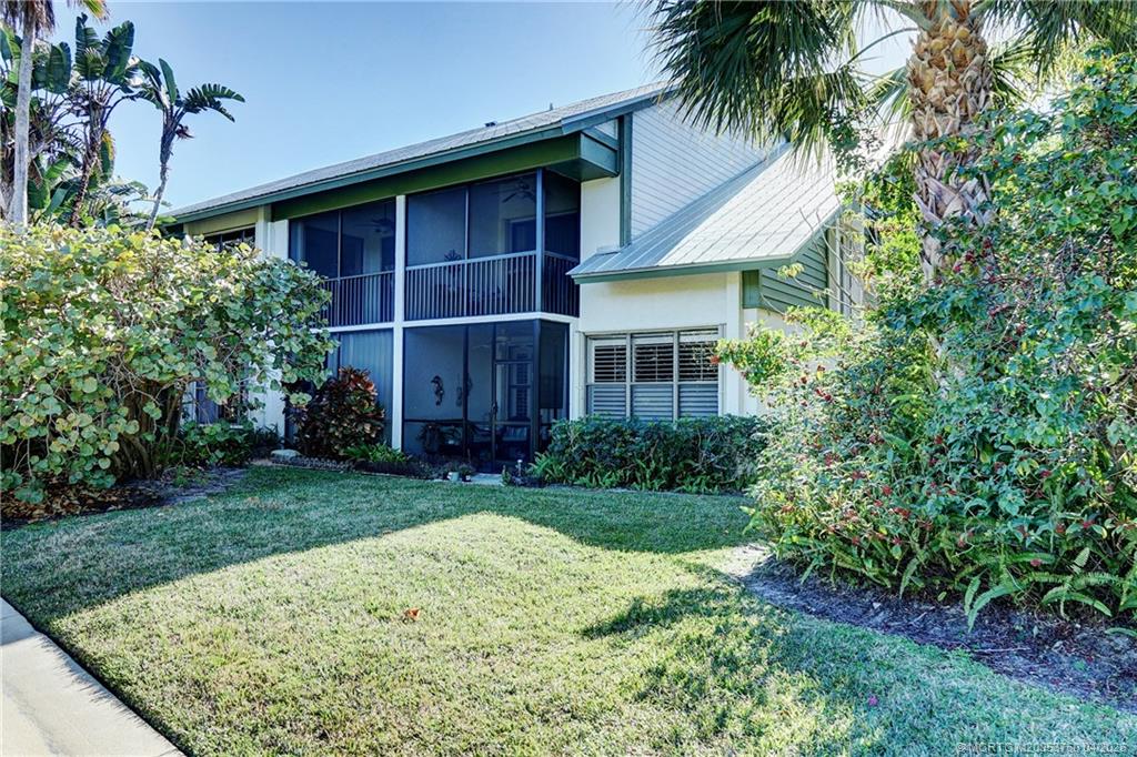 5290 Southeast Seascape Way, Unit 201 Stuart, FL 34997 - Photo 2 of 30 a view of a house with a yard and potted plants