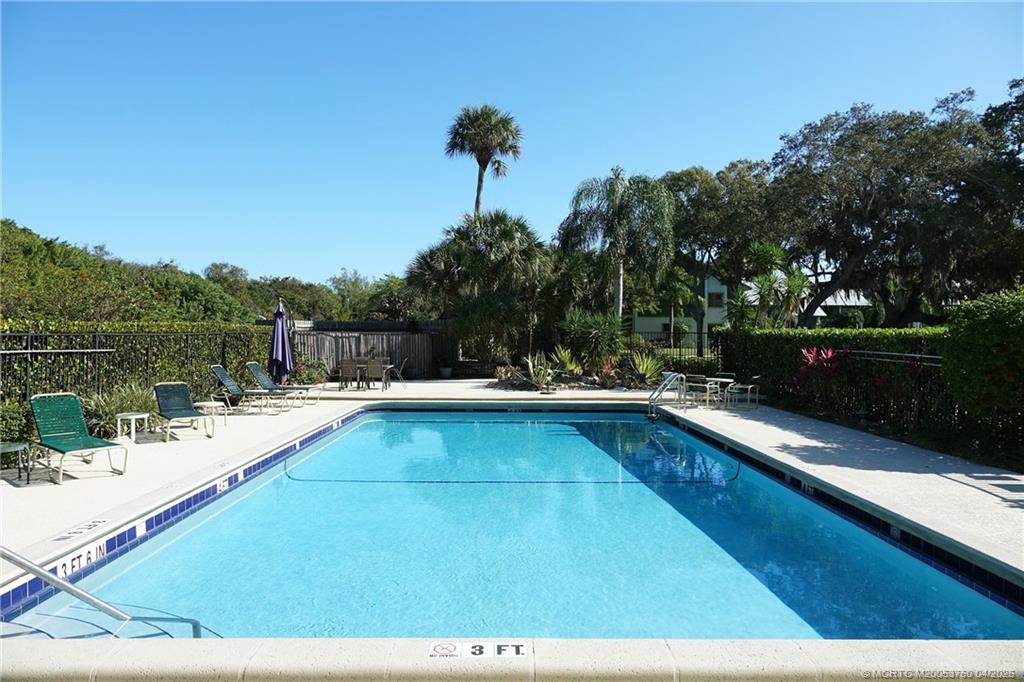 5290 Southeast Seascape Way, Unit 201 Stuart, FL 34997 - Photo 24 of 30 a view of a swimming pool and lounge chair
