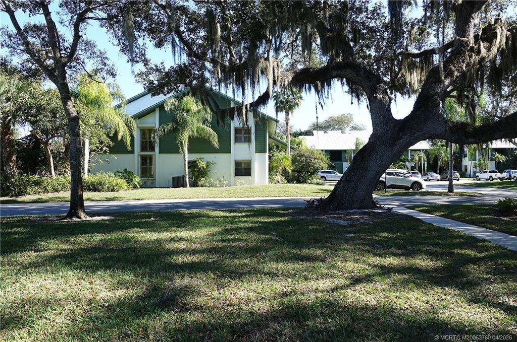 5290 Southeast Seascape Way, Unit 201 Stuart, FL 34997 - Photo 26 of 30 a view of swimming pool with a garden