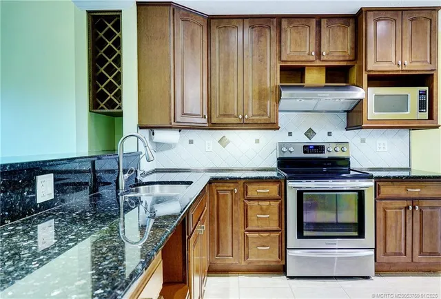a kitchen with wooden cabinets and a stove top oven