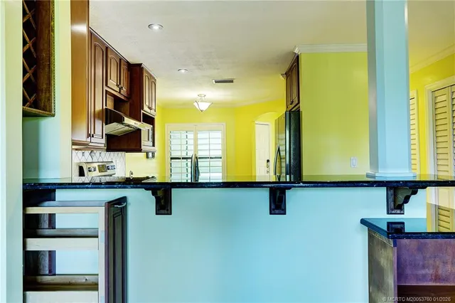 a view of a kitchen with a sink and cabinets