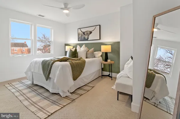 a bedroom with a bed and a painting on the wall