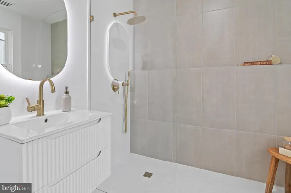 a bathroom with a sink a mirror and shower curtain