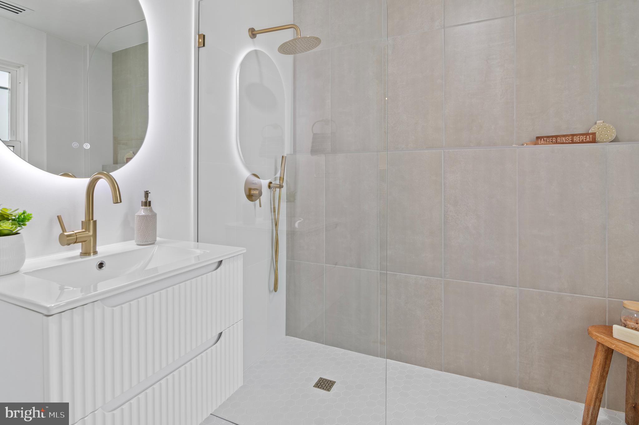5905 Glenkirk Road Baltimore, MD 21239 - Photo 16 of 31 a bathroom with a sink and mirror