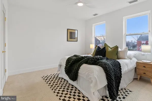 a bed sitting in a bedroom next to a window