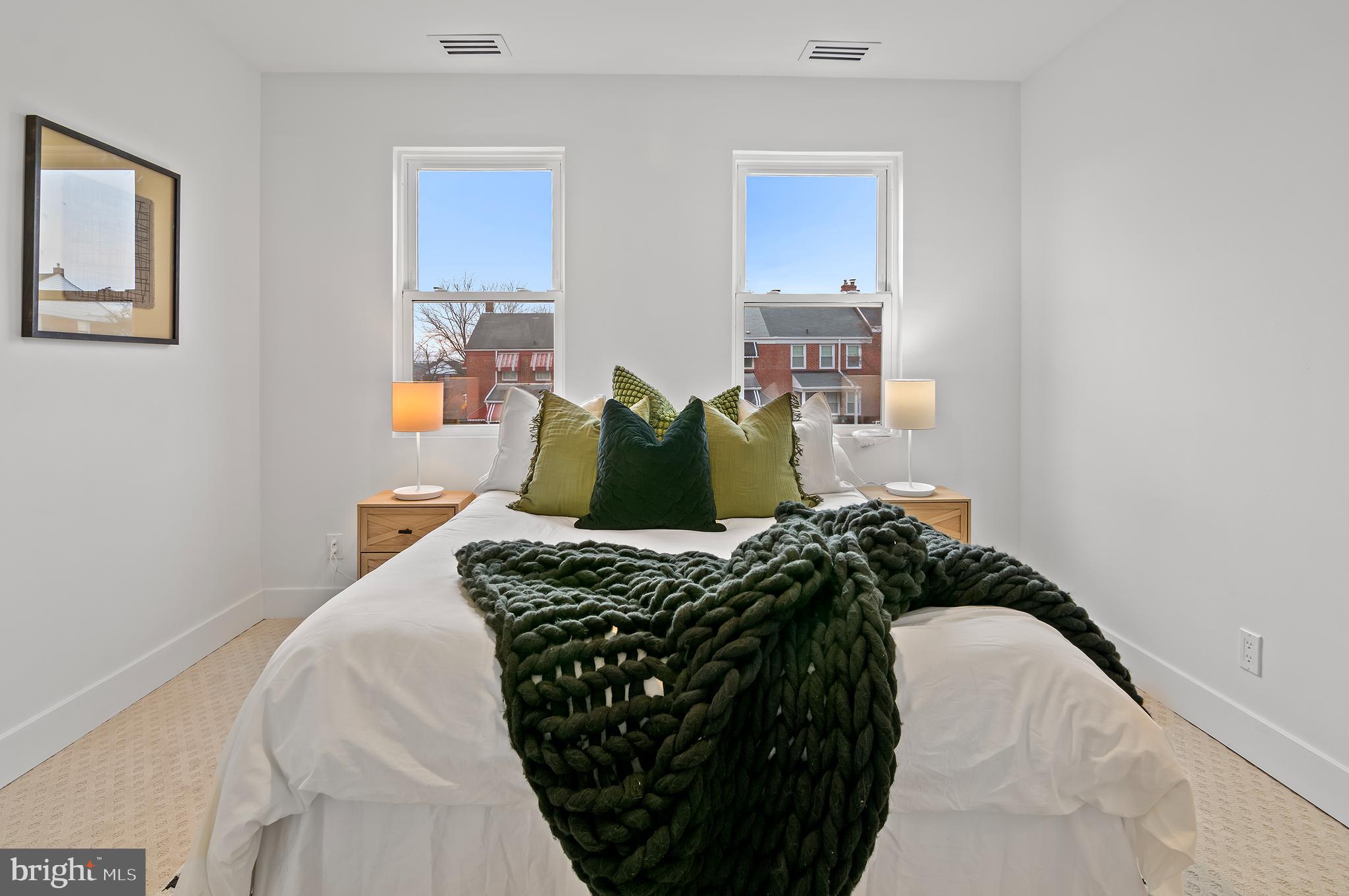 5905 Glenkirk Road Baltimore, MD 21239 - Photo 20 of 31 a bed sitting in a bedroom next to a window