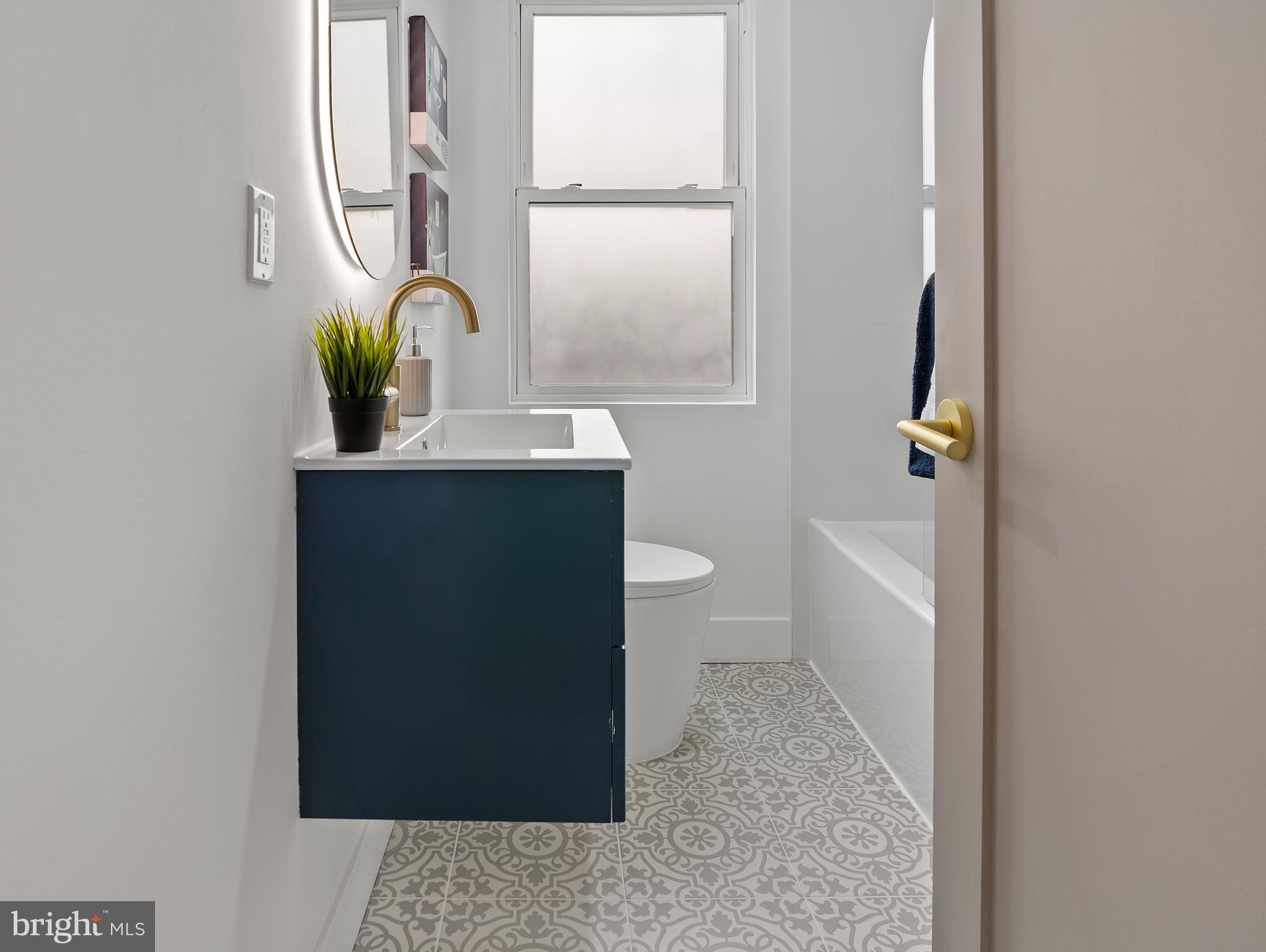5905 Glenkirk Road Baltimore, MD 21239 - Photo 21 of 31 a view of bathroom with a sink and mirror