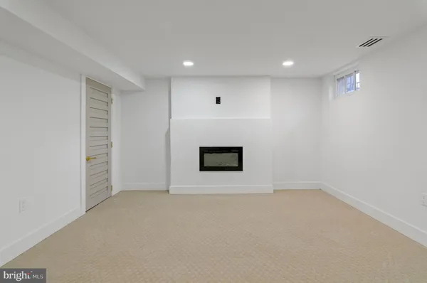 a white toilet sitting next to a shower