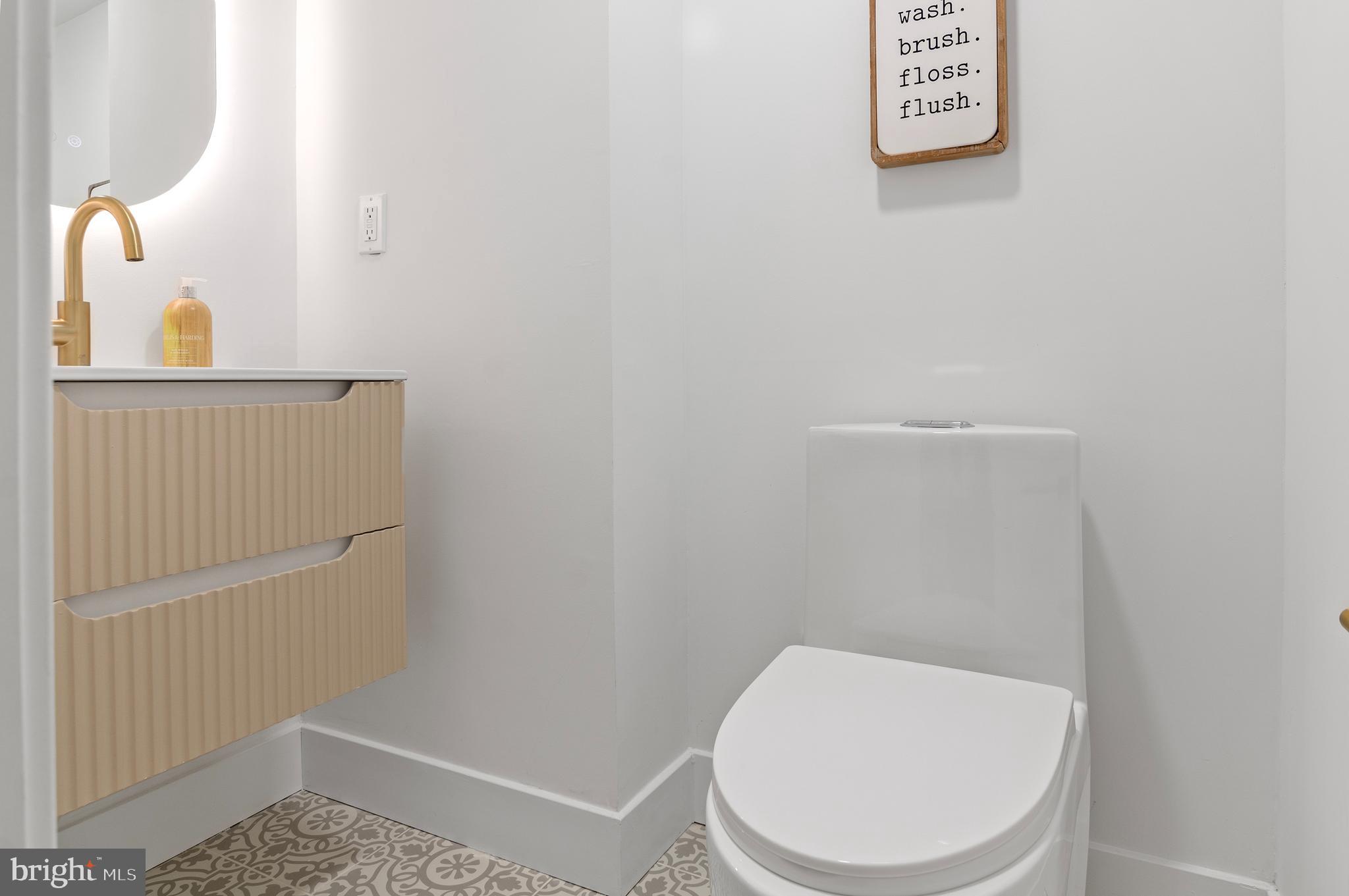 5905 Glenkirk Road Baltimore, MD 21239 - Photo 26 of 31 a white toilet sitting next to a shower